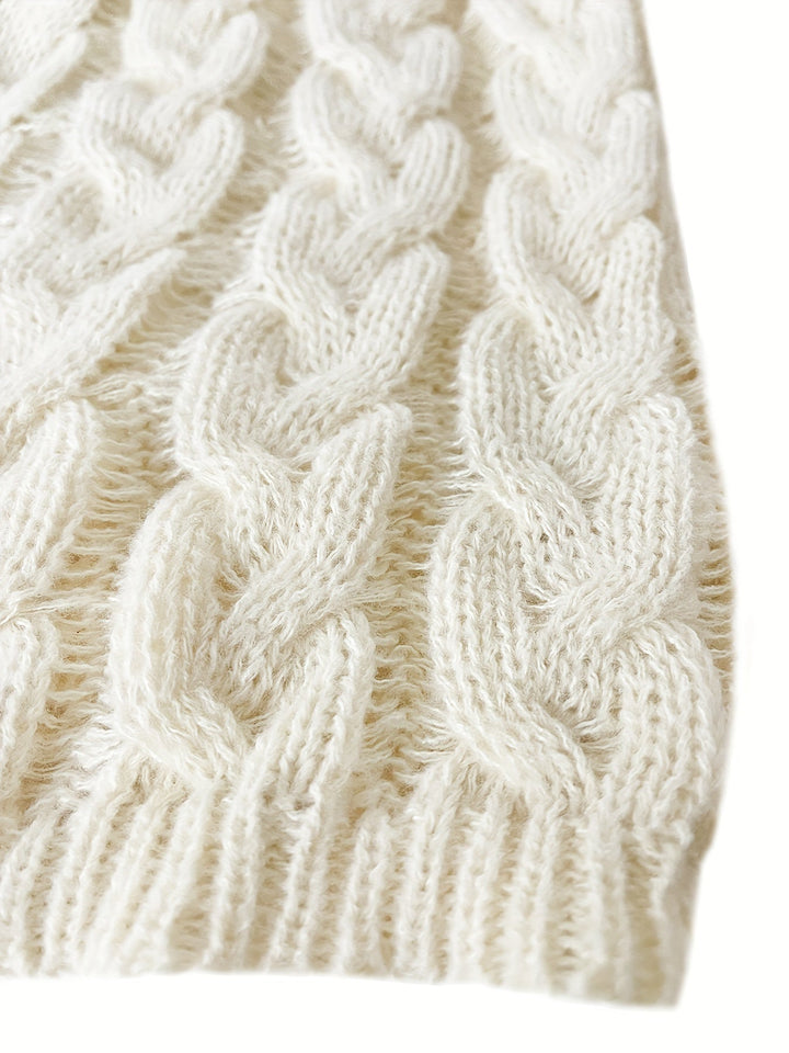 Cream jumper hem with chunky cable twists and a ribbed edge