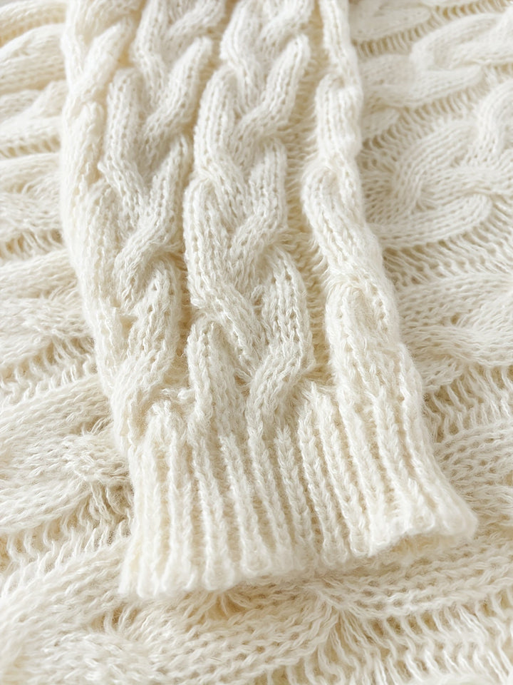 Close up of the cream cable pattern and ribbed sleeve cuff