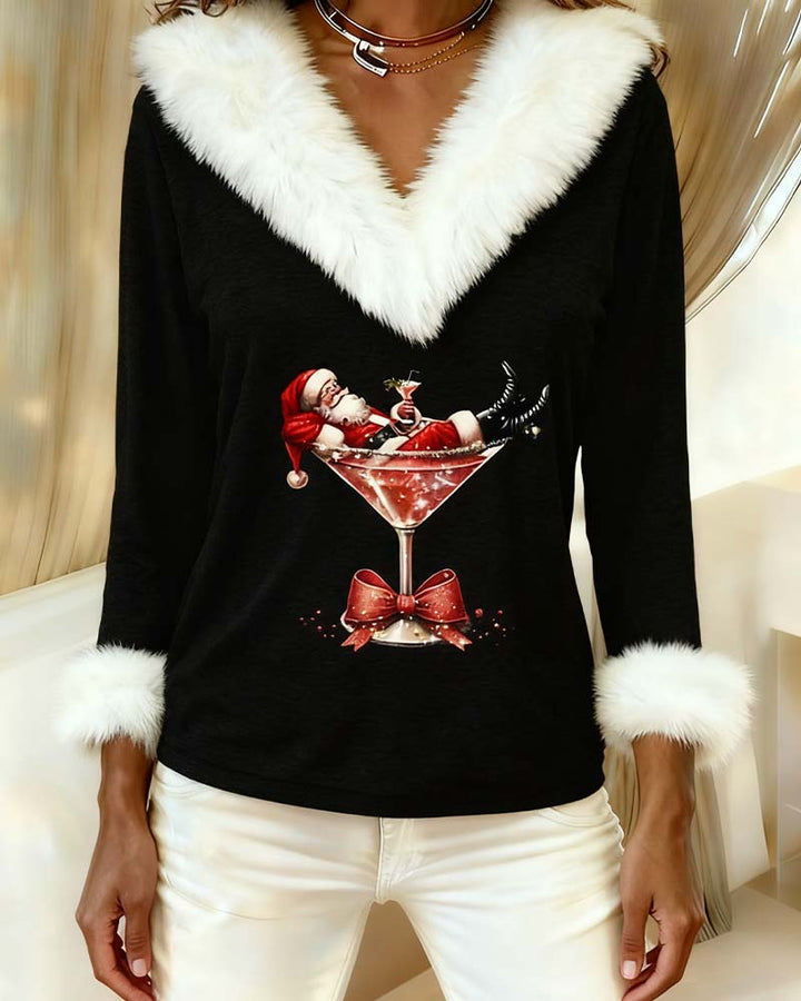 Black Santa print top worn with cream trousers