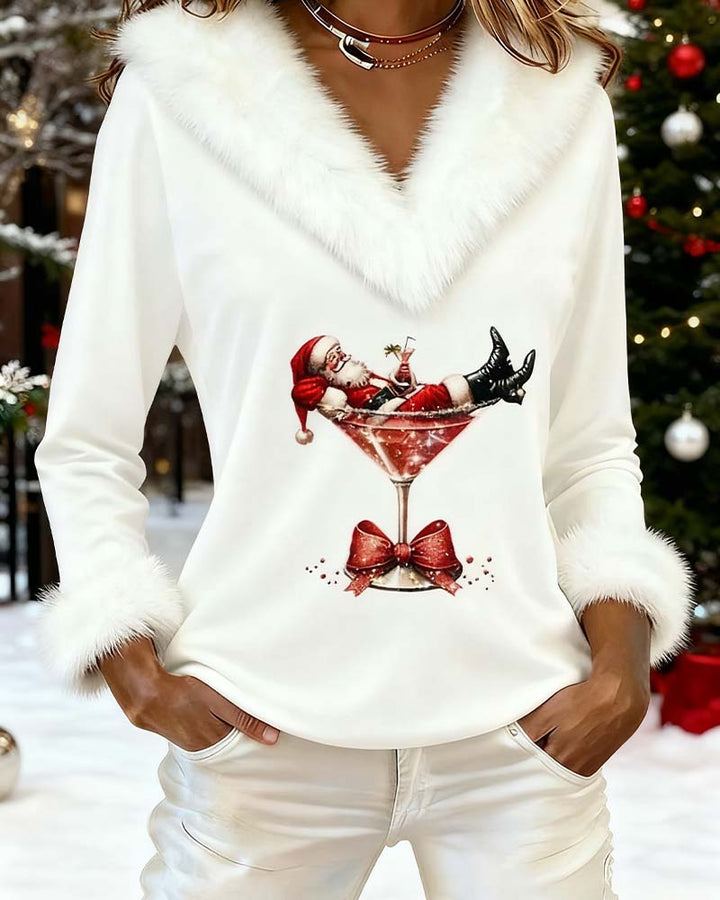 White Santa print top photographed beside a Christmas tree