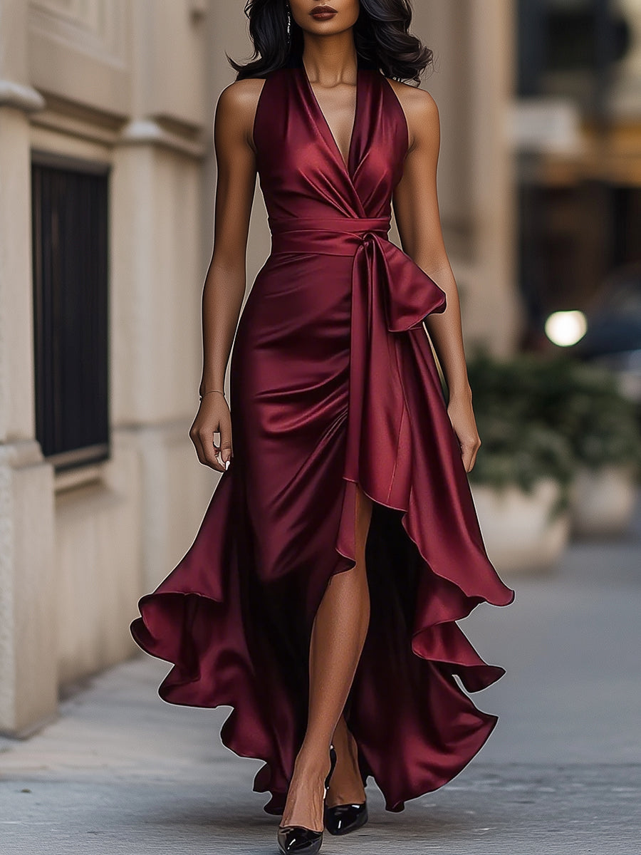 Burgundy halter wrap maxi dress walking on a city pavement