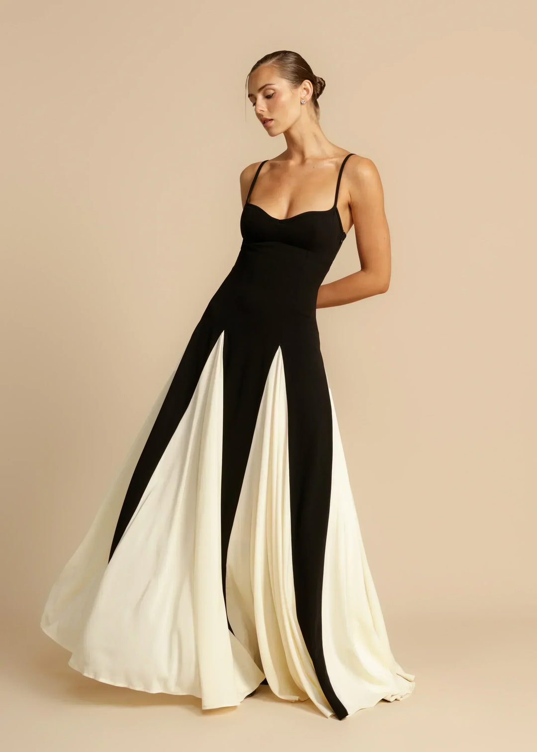 Black and cream maxi gown in motion with the skirt swirling out