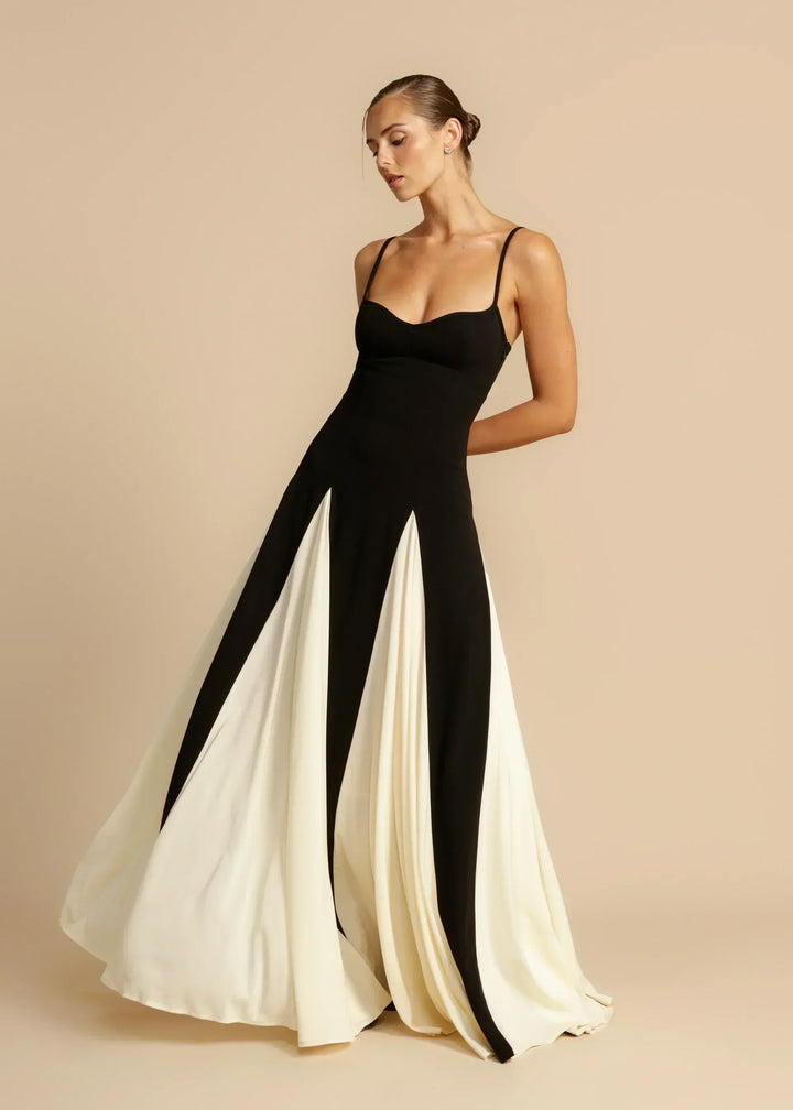 Black and cream maxi gown in motion with the skirt swirling out