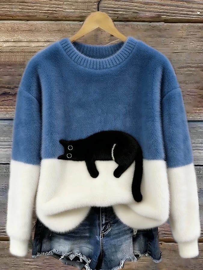 Mid blue fluffy jumper with cream lower half and black cat stretched out