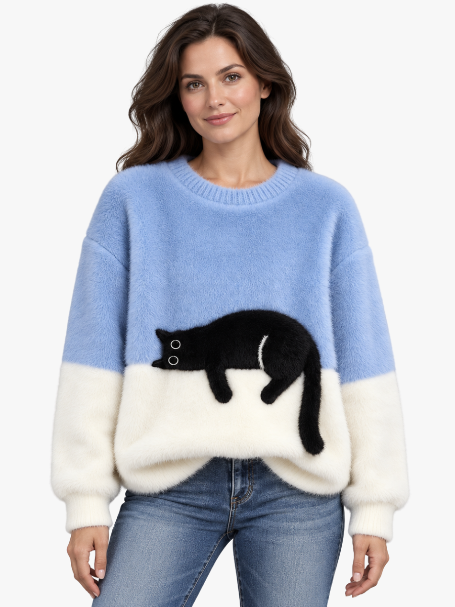 Woman wearing the light blue cat jumper with blue denim-look trousers