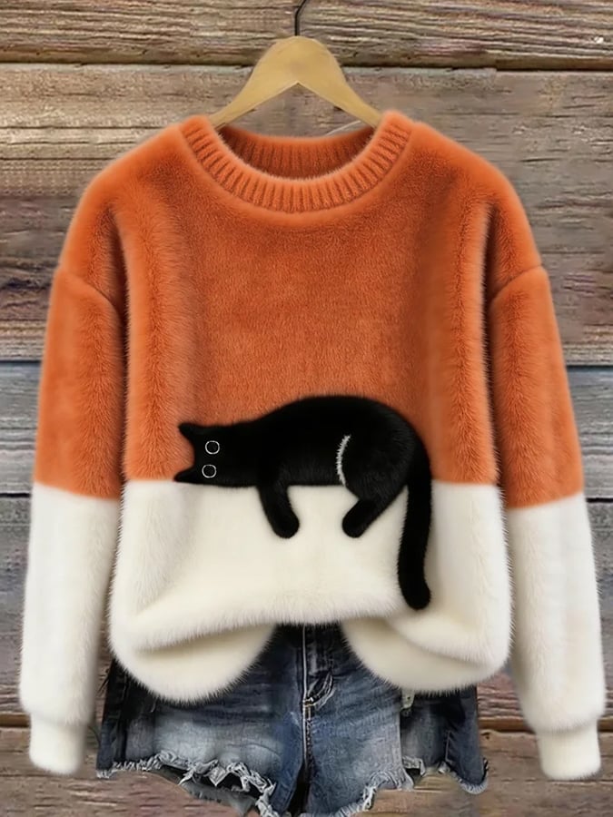 Orange fluffy jumper with cream lower half and black cat motif