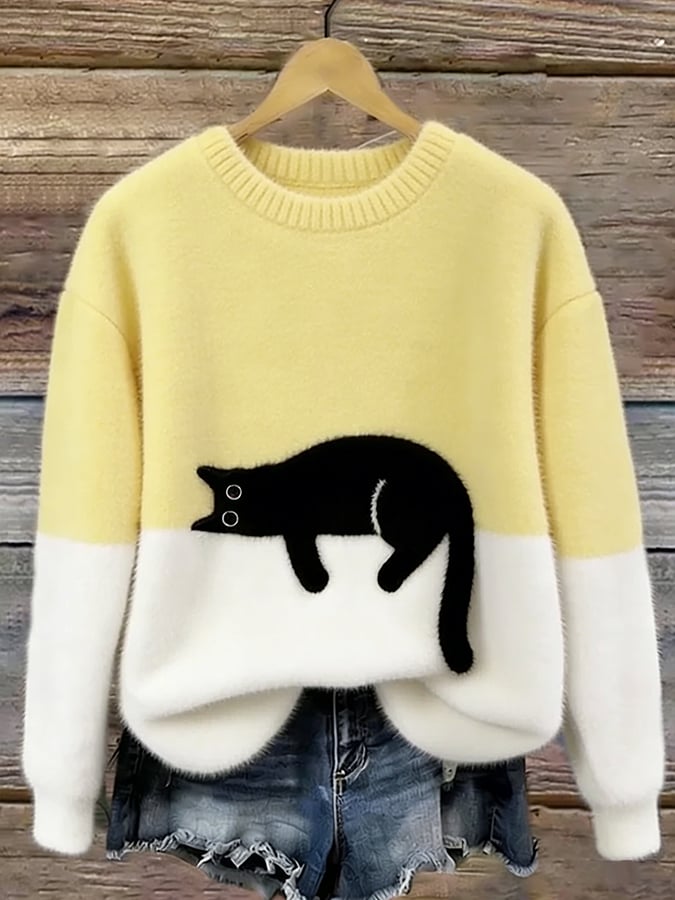 Pale yellow and cream fluffy jumper with a black cat
