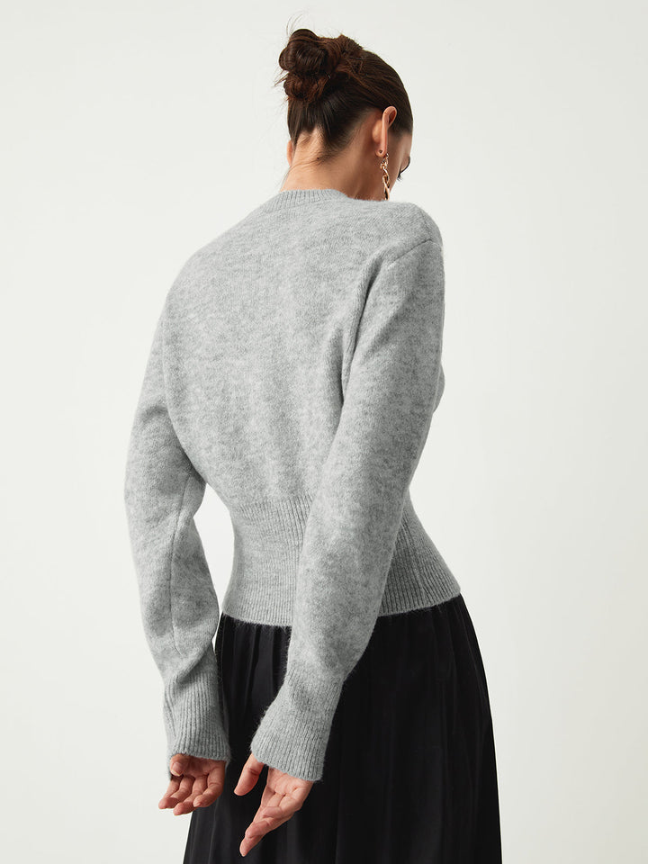 Back view of the grey jumper showing the fitted waist