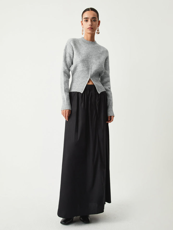 Model in the grey jumper with a black maxi skirt, full length