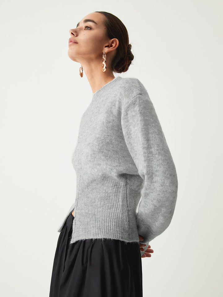 Side view of the grey fluffy jumper with dropped shoulders