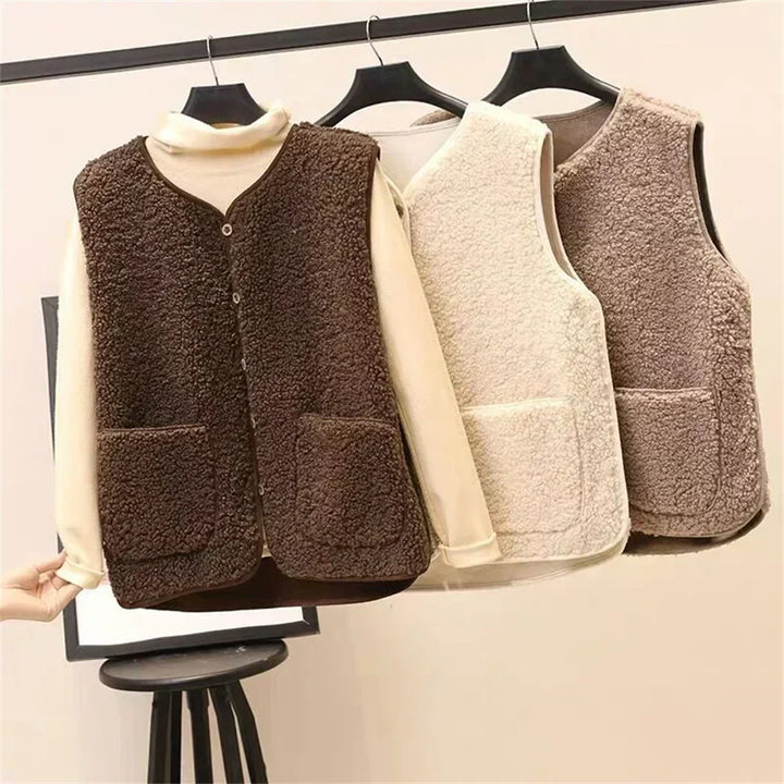 Three teddy gilets in dark brown, beige and taupe on a rail