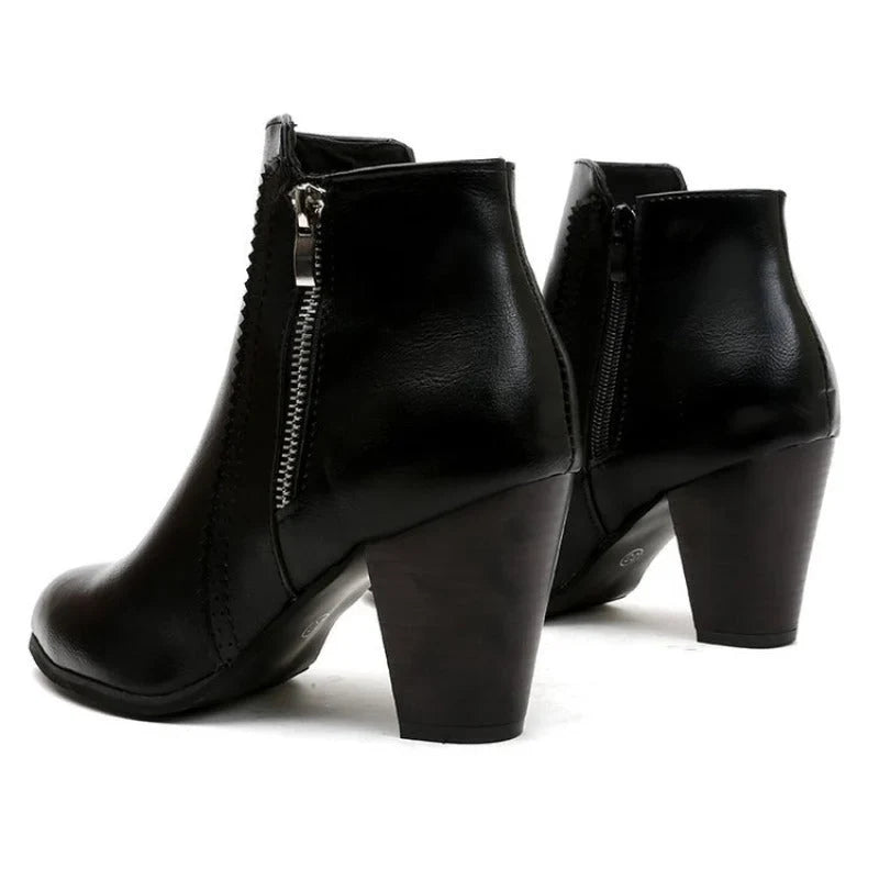 Black ankle boots from behind showing the stacked block heel