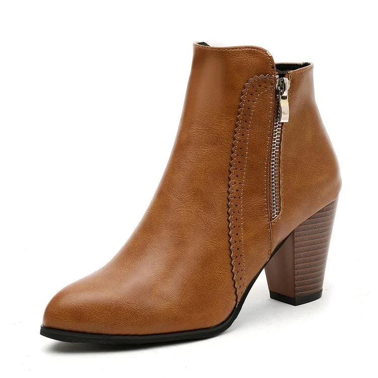 Brown heeled ankle boot side view with pointed toe and side zip