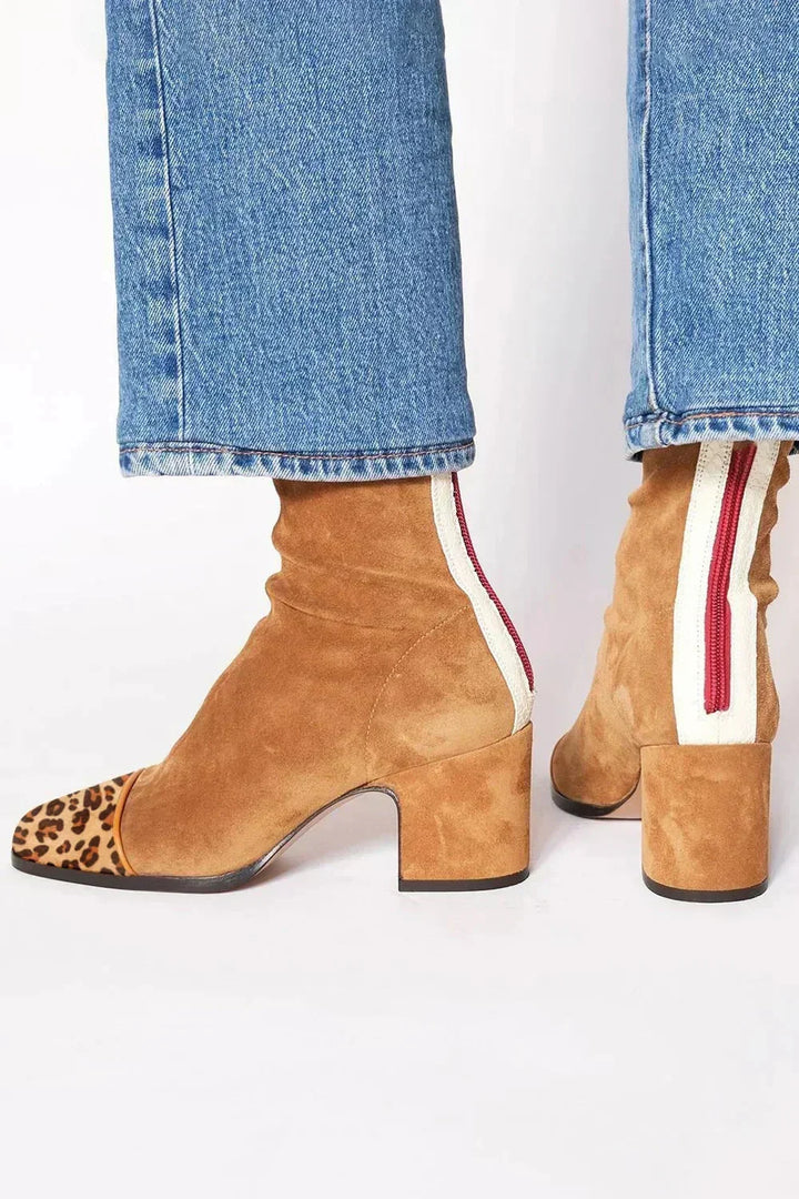 Tan ankle boots with a leopard toe cap and striped back tab