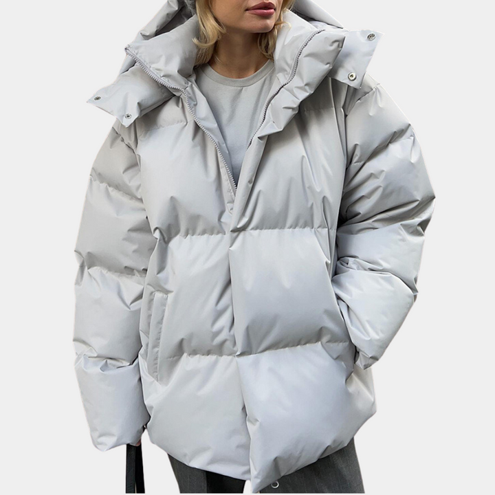 Light grey oversized puffer jacket worn open with the hood folded back