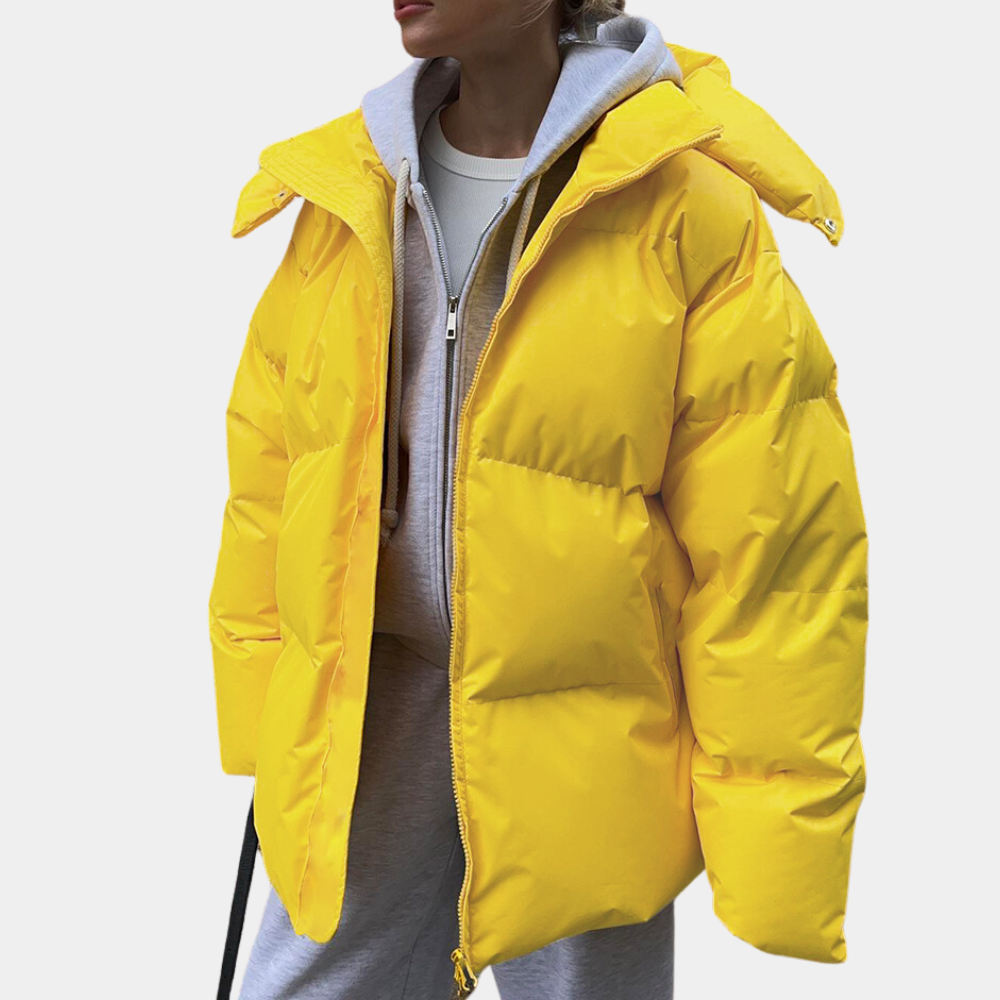 Yellow oversized puffer jacket worn open over a grey hoodie
