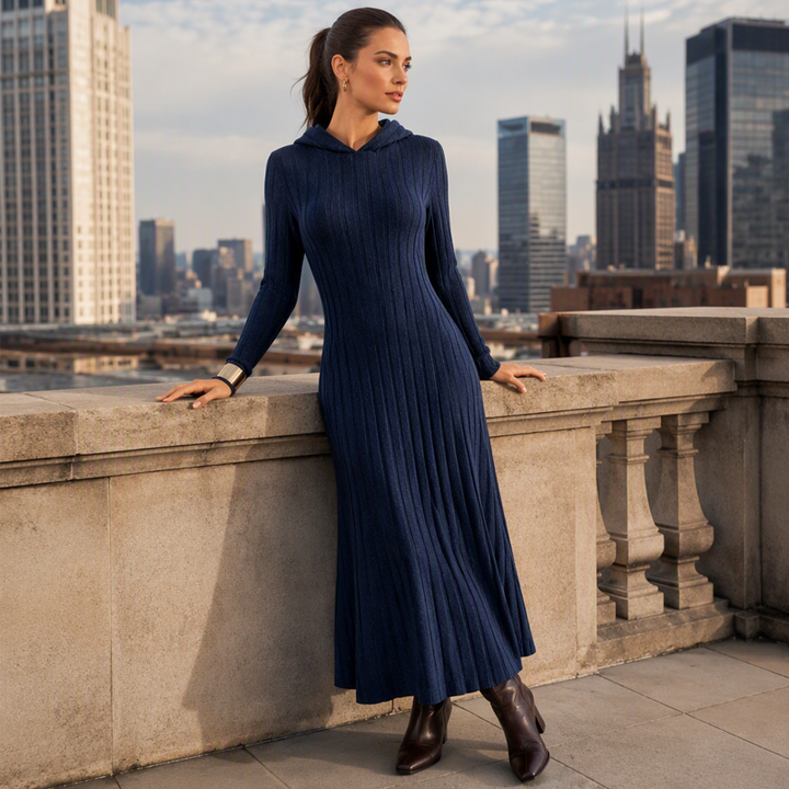 Navy blue hooded maxi dress worn on a city balcony with boots