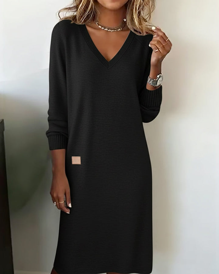 Black V neck jumper dress worn with a silver necklace