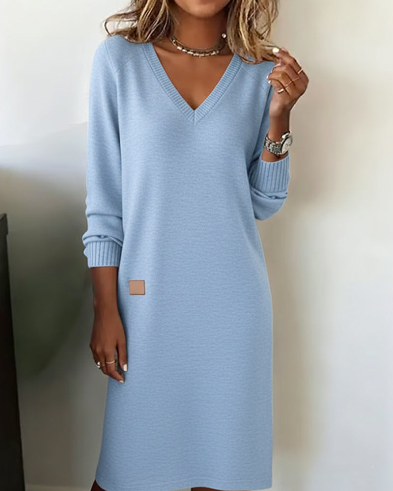 Light blue jumper dress with a V neckline and long sleeves