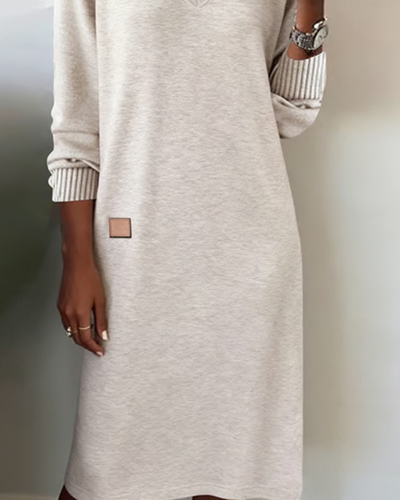 Light grey knitted dress from the side with ribbed cuffs