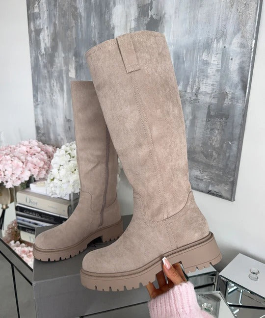 Beige knee high boots showing the pull tab and chunky tread