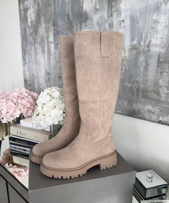 Beige suede-look knee high boot with a cream lug sole, side view