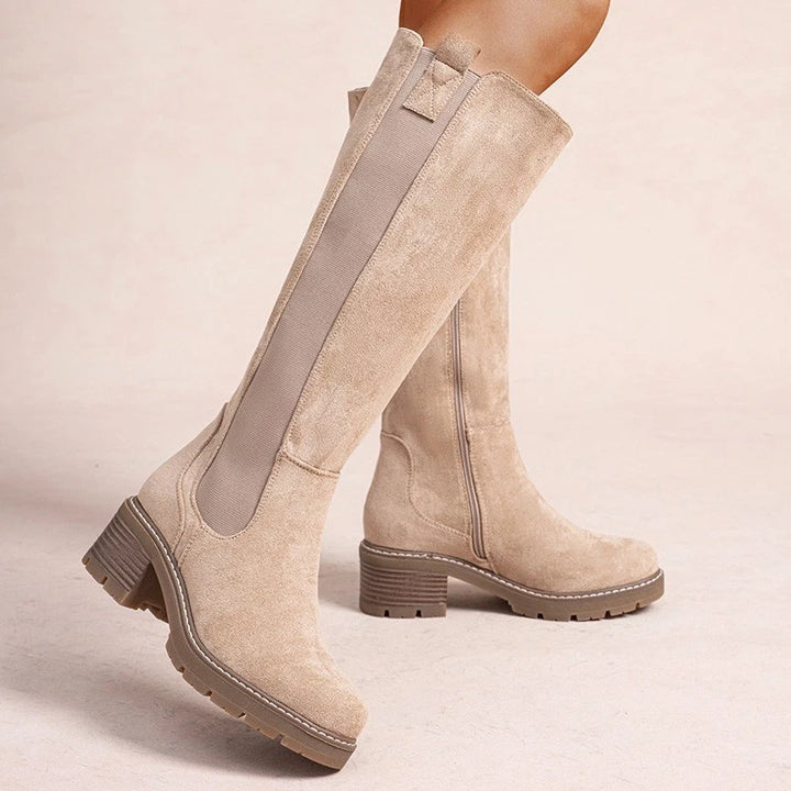 Beige knee high boots, worn on foot, front view