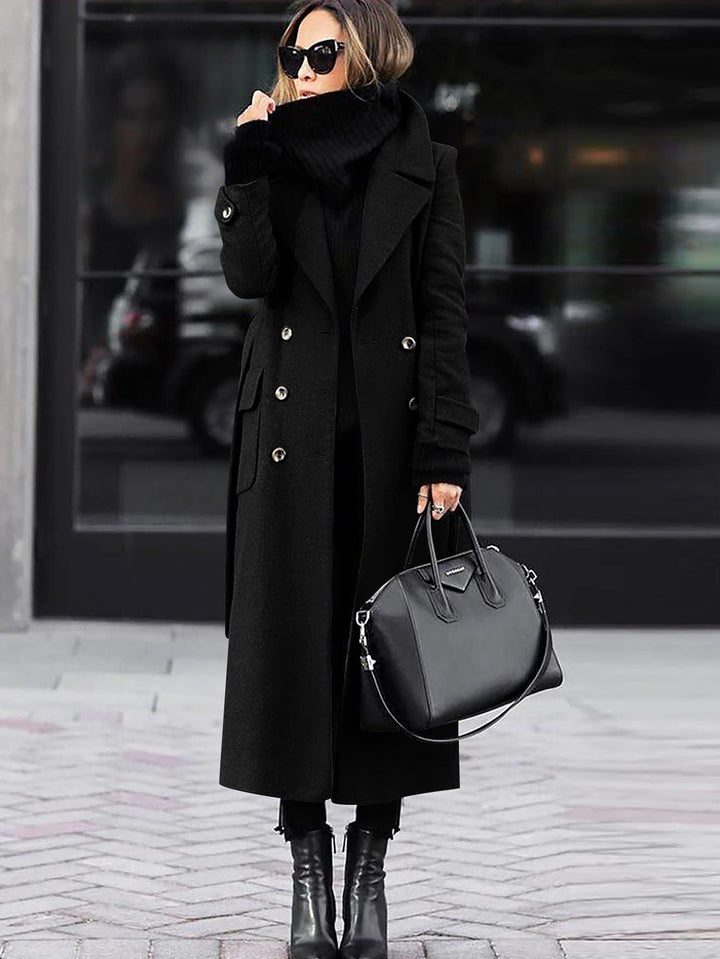 Black full length coat worn with ankle boots in the city