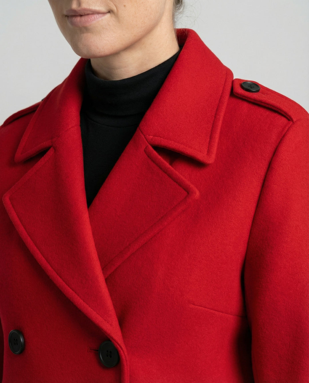 Close-up of the notch lapel and buttons on the red coat