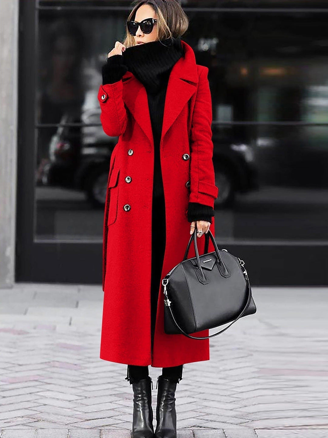 Red long coat worn open on a city street with a black bag