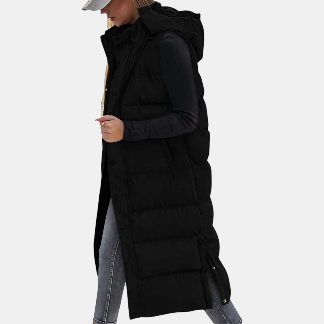 Black long puffer gilet with hood worn over a black top