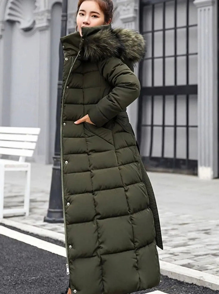 Army green long puffer coat with hand in the side pocket