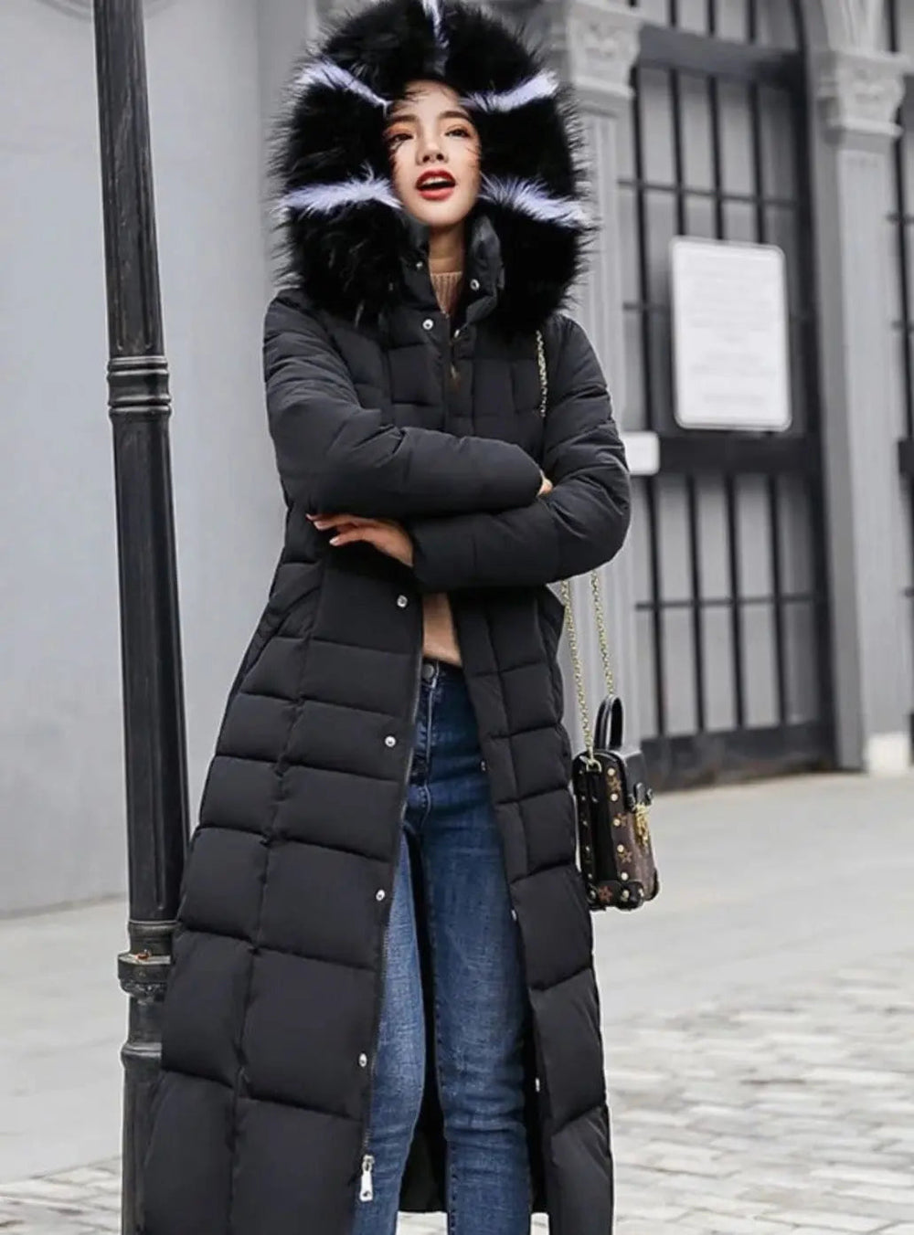Black long puffer coat with the fur trimmed hood up