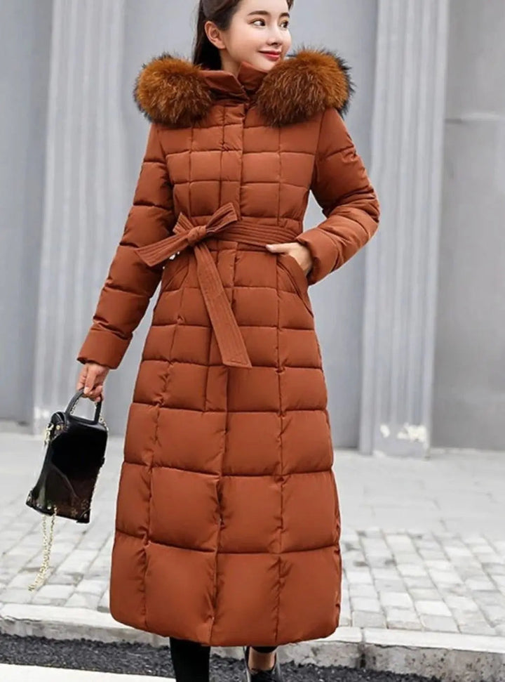 Women's long puffer coat in caramel, belted quilted with faux fur hood