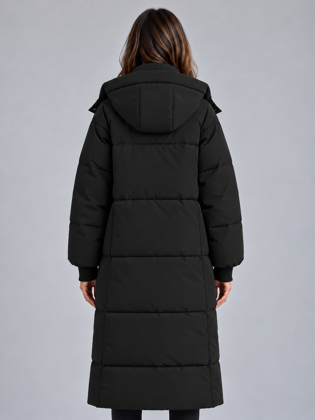 Back view of the black long puffer coat with hood and quilted panels