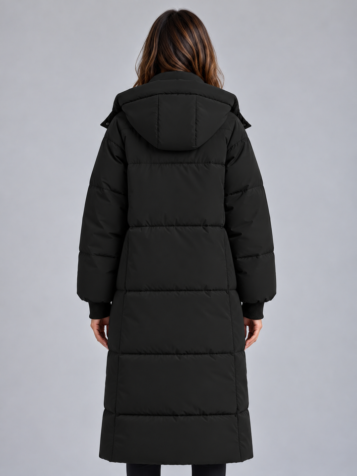 Back view of the black long puffer coat with hood and quilted panels