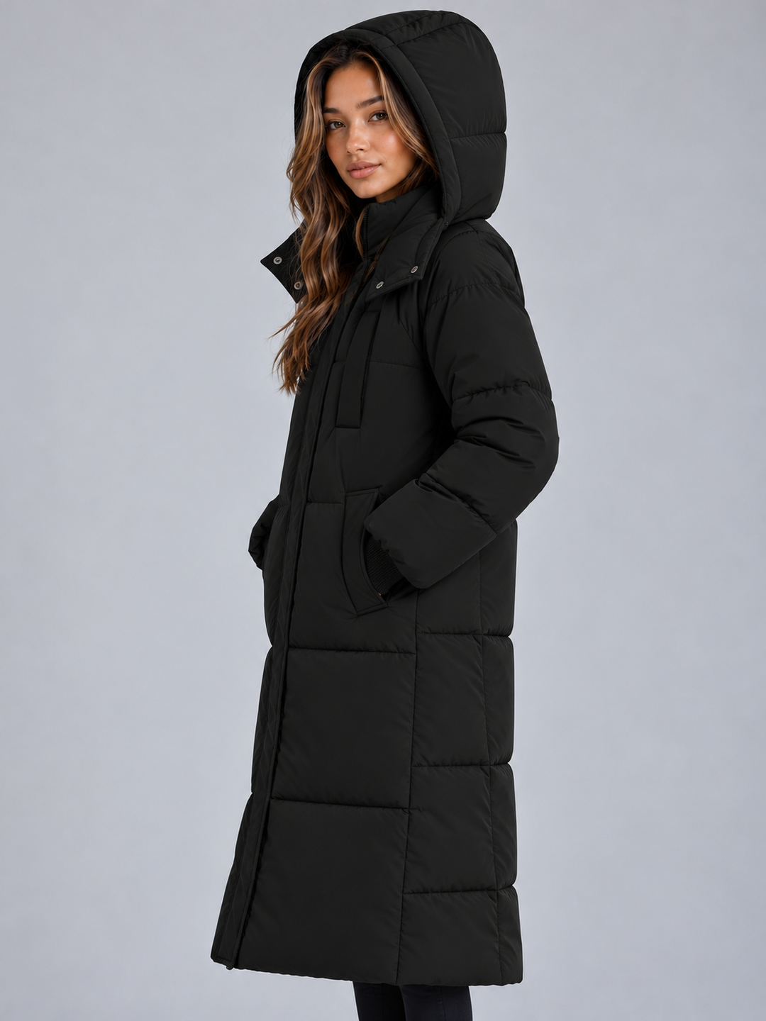 Side view of the black puffer coat with the hood up