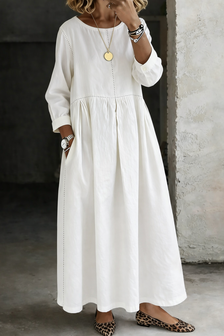 White long sleeve maxi dress with gathered skirt and side pockets