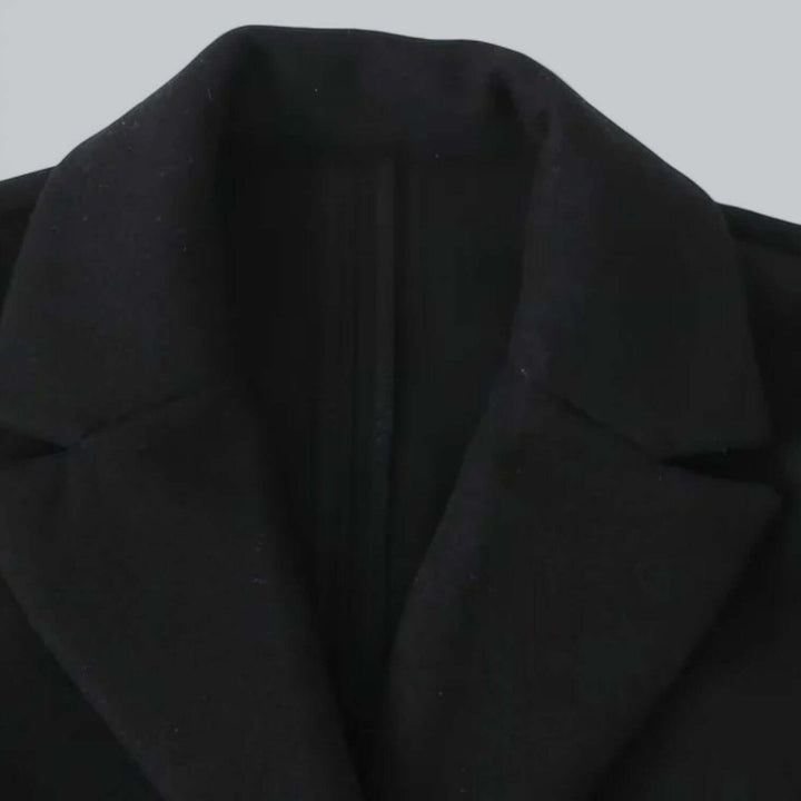 Detail of the black coat lapel and front edge