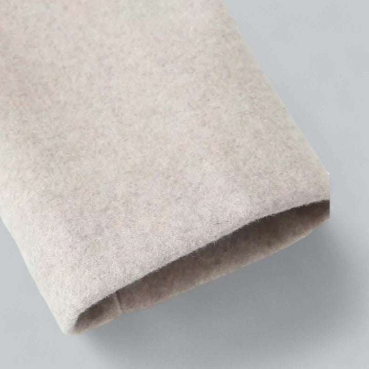 Oatmeal coat sleeve cuff in close up