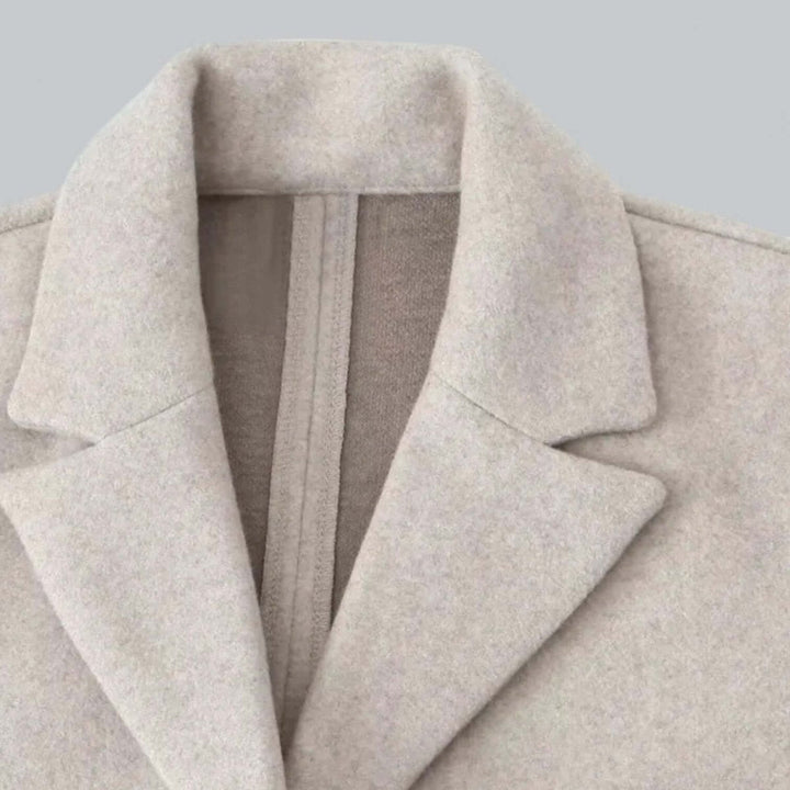 Close up of the oatmeal coat notch lapel and brushed finish