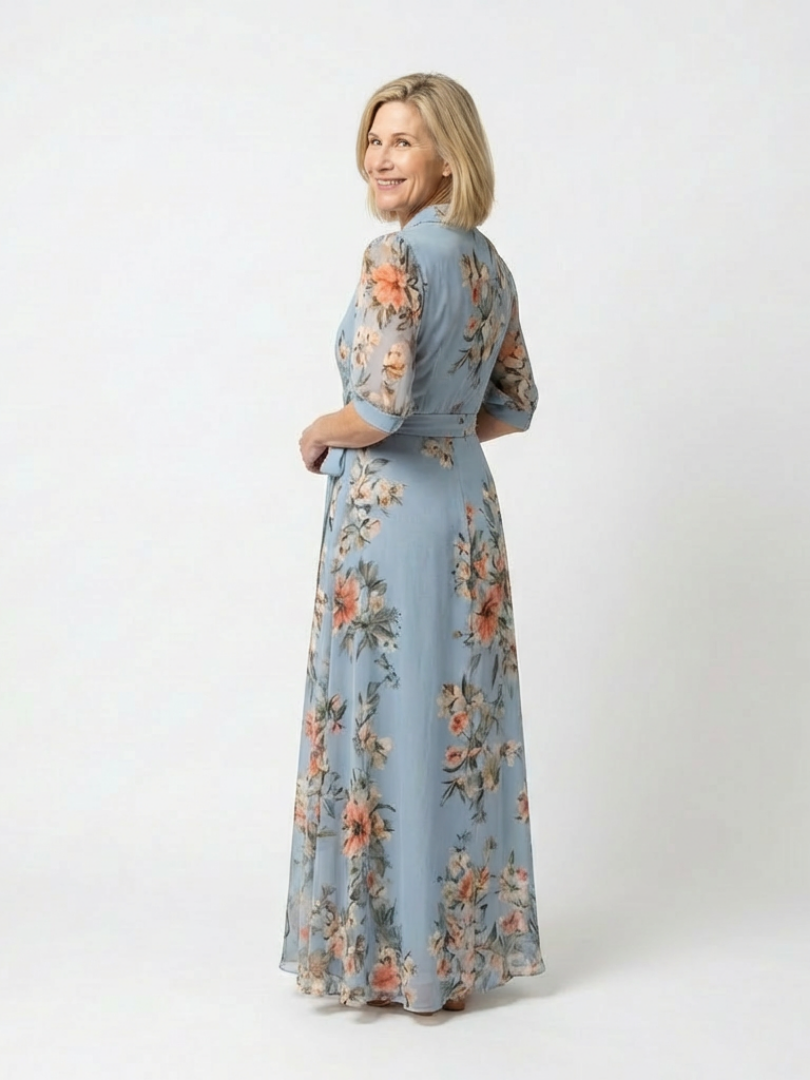 Back view of the blue floral dress with sheer elbow sleeves