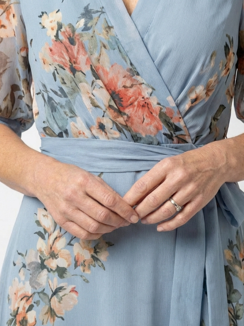 Close up of the wrap V neckline, floral print and tied belt