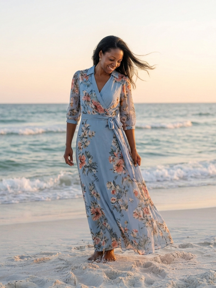 Woman walking barefoot on the beach in the floaty floral dress