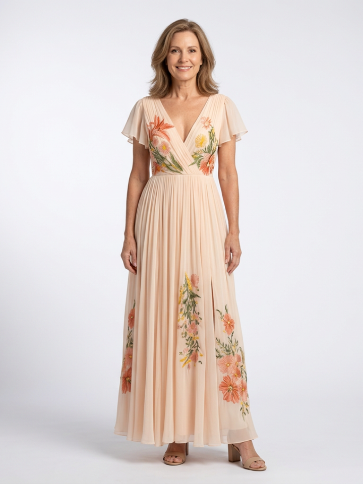 Women's maxi dress in peach with floral embroidery, flutter sleeves and pleated skirt