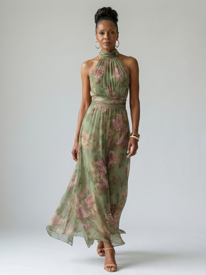 Sage green floral halter dress worn by a model with her hair in a bun