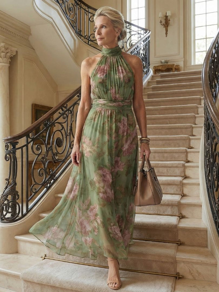 Floaty sage floral dress worn walking on a grand staircase