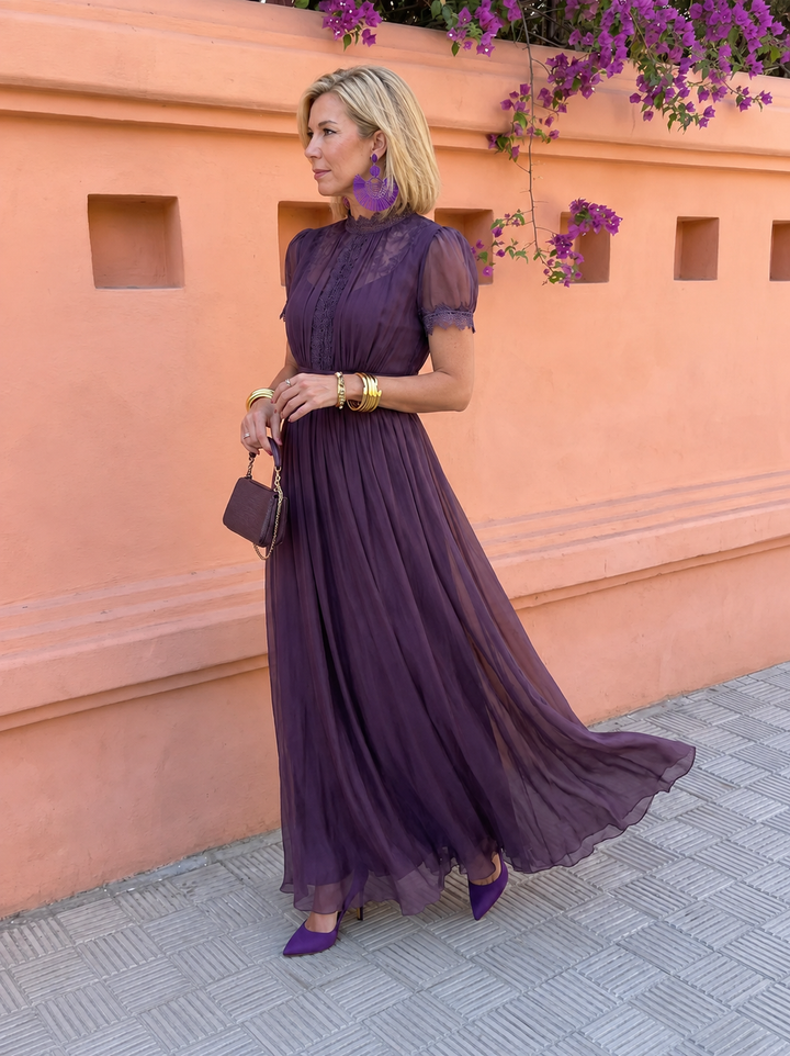 Side view of the plum dress in motion with flowing hem