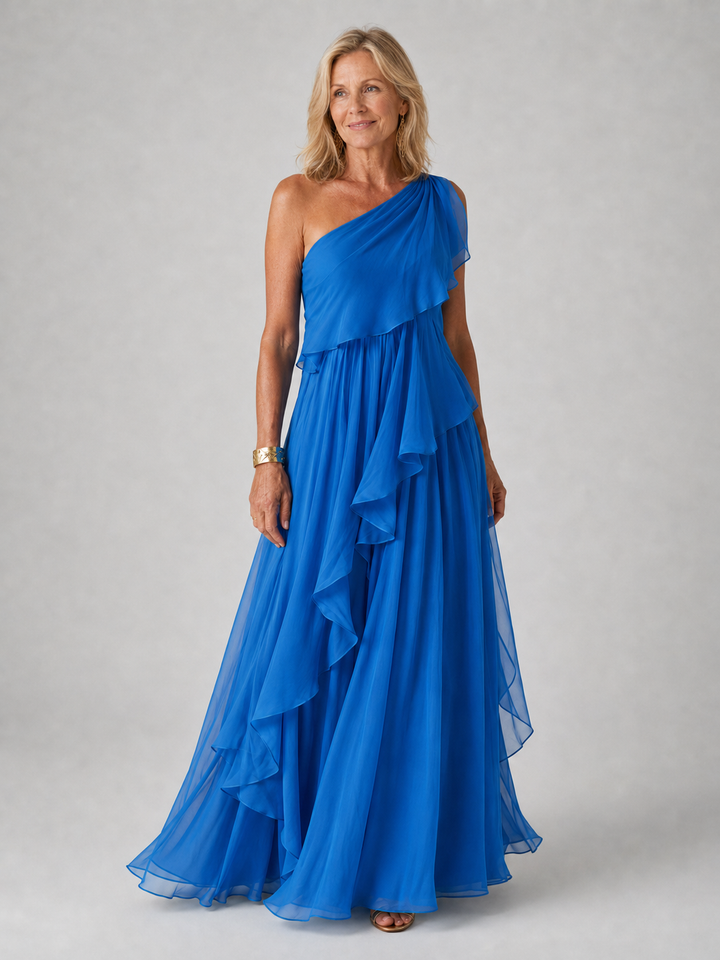 Cobalt blue one-shoulder dress with ruffle cascading along the side