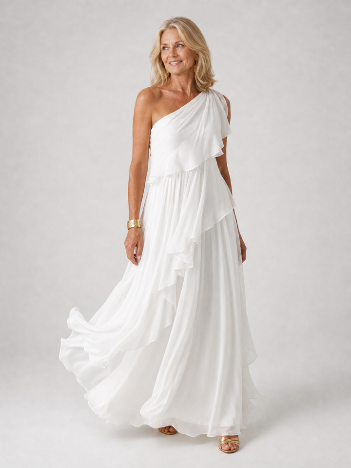 White floor-length dress with side ruffle swirling at the hem